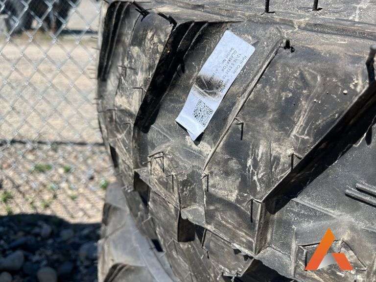 (4) Unused 12-16.5 skid steer tires on wheels for Bobcat