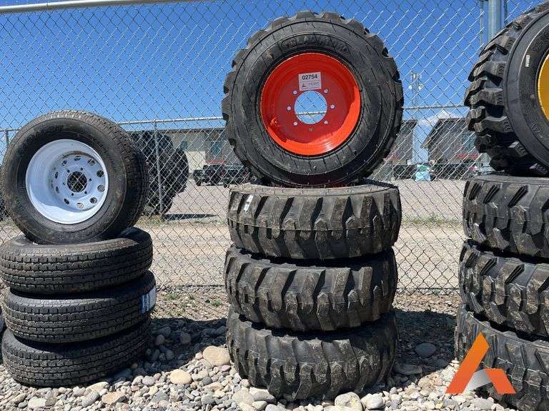 (4) Unused 12-16.5 skid steer tires on wheels for Bobcat