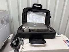 Copiers, paper feeder, scanners, projector, small office items, large wooden storage shelf, small de