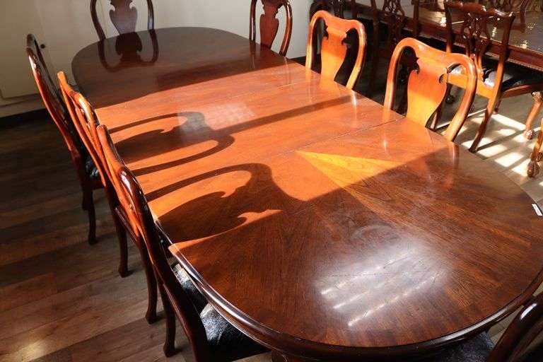 Ornate and elegant 45" x 114" long dining room table with 8 chairs (2 are captains chairs) with heavy black decorative vinyl padded seats