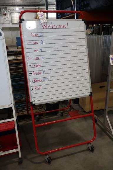 A framed metal portable dual sided dry erase board stand