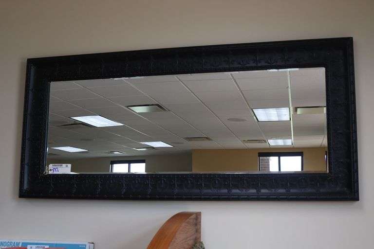 Ornate tin framed 33" x 72" beveled edge mirror