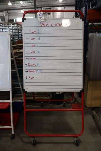 A framed metal portable dual sided dry erase board stand