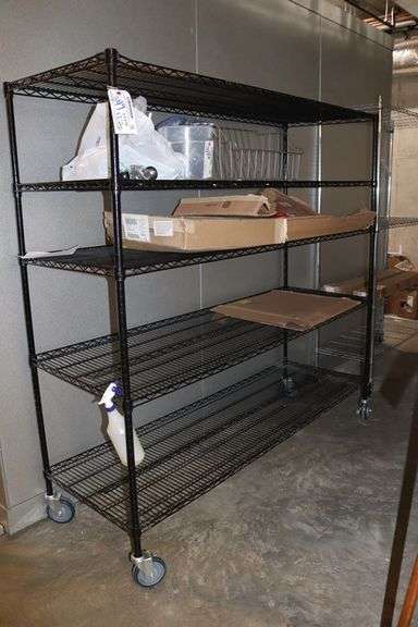 Times 2 - 24" x 72" portable black coated racks - one located in walk in cooler