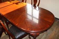 Ornate and elegant 45" x 114" long dining room table with 8 chairs (2 are captains chairs) with heavy black decorative vinyl padded seats
