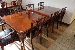 Orante and elegant 46" x 100" long dining room table with 8 chairs (2 are captains chairs) with heavy black decorative vinyl padded seats