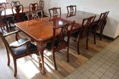 Orante and elegant 46" x 100" long dining room table with 8 chairs (2 are captains chairs) with heavy black decorative vinyl padded seats