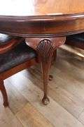 Ornate and elegant 45" x 114" long dining room table with 8 chairs (2 are captains chairs) with heavy black decorative vinyl padded seats