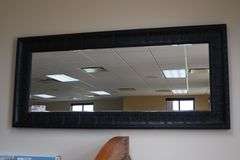 Ornate tin framed 33" x 72" beveled edge mirror