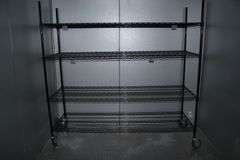 Times 2 - 24" x 72" portable black coated racks - one located in walk in cooler