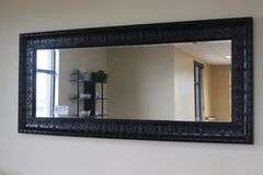 Ornate tin framed 33" x 72" beveled edge mirror