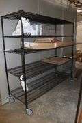 Times 2 - 24" x 72" portable black coated racks - one located in walk in cooler
