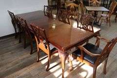 Orante and elegant 46" x 100" long dining room table with 8 chairs (2 are captains chairs) with heavy black decorative vinyl padded seats