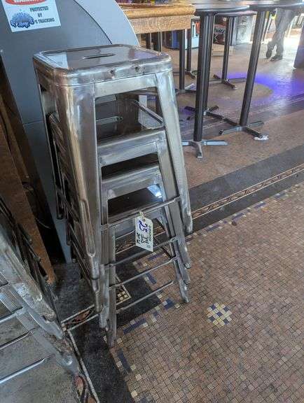 Times 4 - 24" tall silver metal bistro style stools - showing some rust - buyer to view