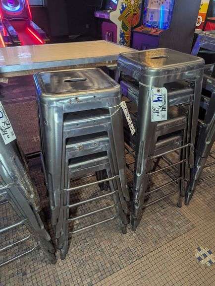 Times 4 - 24" tall silver metal bistro style stools - showing some rust - buyer to view