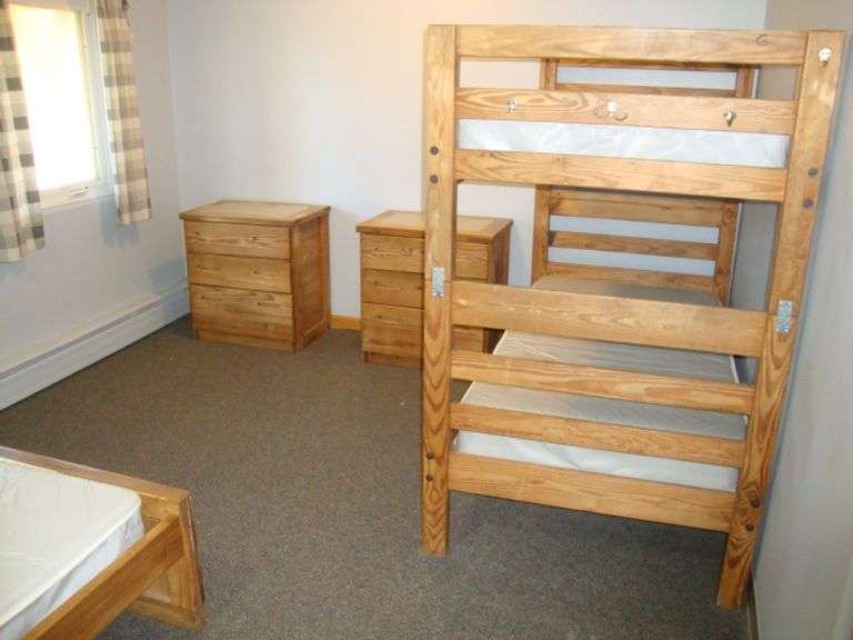 Contents of room including Well-Built Solid Fir/Pine Bunk bed, single bed, and 3 dressers Great for deer hunters cabin!