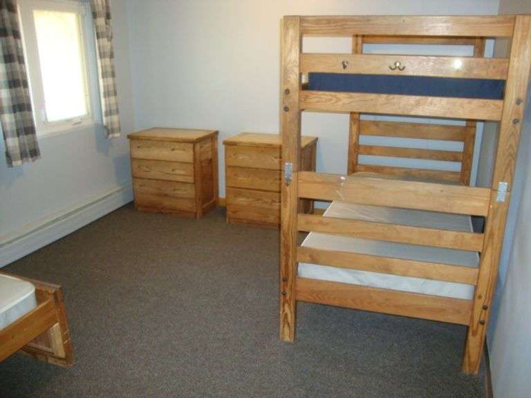 Contents of room including Well-Built Solid Fir/Pine Bunk bed, single bed, and 3 dressers Great for deer hunters cabin!