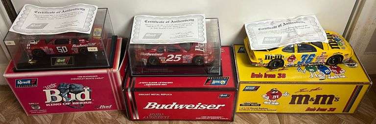 (3) 1:24 Scale Diecast Replica Cars w/ COA's, 1998 Budweiser/Louie Chevrolet Monte Carlo, 1998 Budweiser Chevrolet Monte Carlo, & 1998 M&M's Pontiac Grand Prix, All In Original Packaging