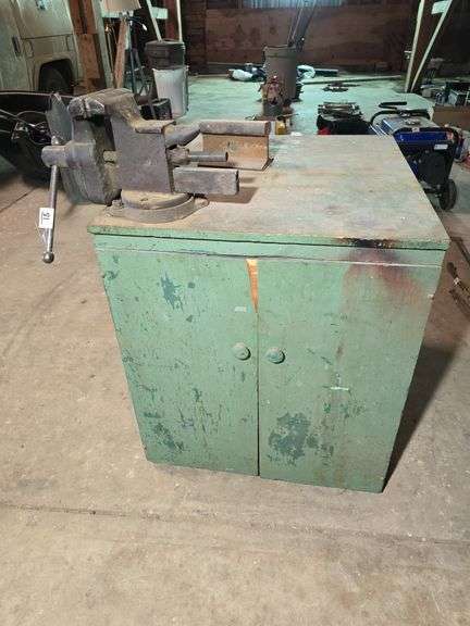 WOOD CABINET WITH NICE BENCH VISE AND CHUNK OF RAIL ROAD.