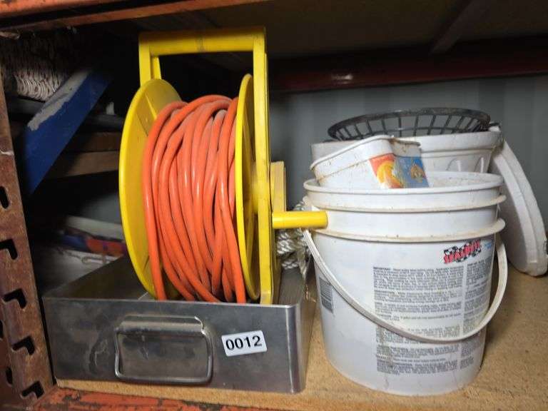 EXTENSION CORD ON REEL AND BUCKET OF HARDWARE.