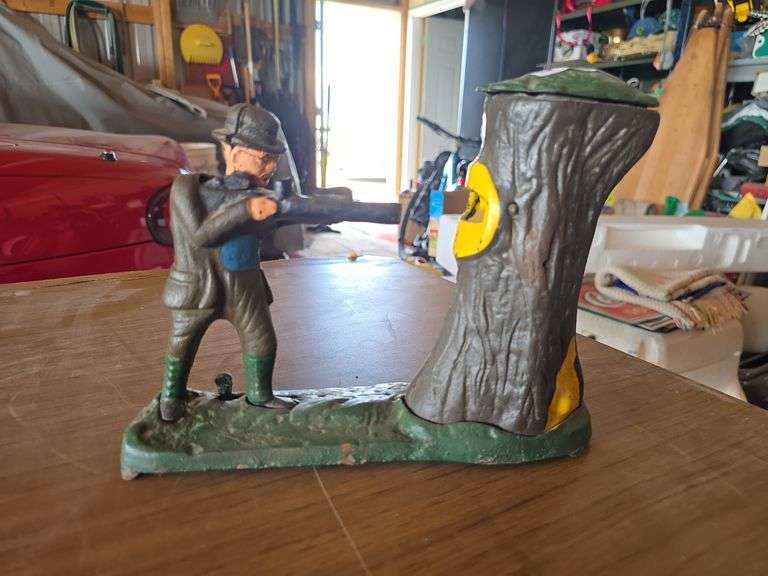 PIGGY BANK, SHOOTS COIN INTO TREE AND BEAR POPS OUT.