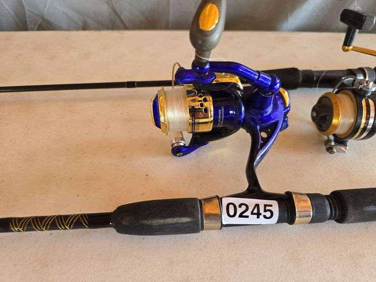 2- FISHING POLES, BLUE REEL LIGHTS UP WHEN BEING REELED.