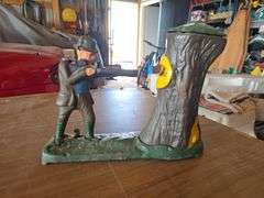 PIGGY BANK, SHOOTS COIN INTO TREE AND BEAR POPS OUT.