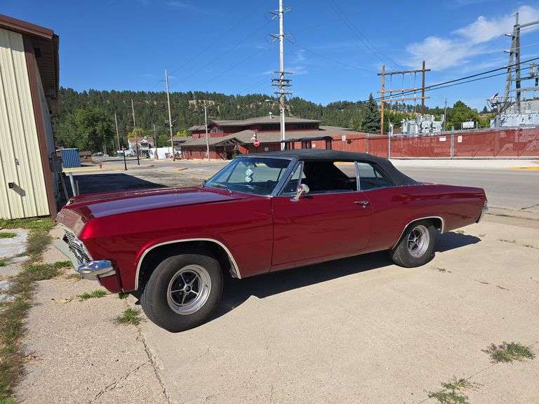 1965 CHEVROLET IMPALA CONVERTIBLE. NON-ORIGINAL 350CI ENGINE, AUTOMATIC. GOOD TIRES. RESTORED IN APPROX 2019. NEW CONVERTIBLE TOP. RUNS AND DRIVES GOOD. NEW FENDERS, QUARTERS, FLOOR PANS, TRUNK FLOOR. FRONT DISC BRAKES, REAR DRUMS. NO RUST. HOOD NEEDS ALIGNED. FEW HAIL DINGS BETWEEN TRUNK LID AND TOP. PAINT COLOR IS RUBY RED EFFECT. THIS CAR LOOKS GREAT AND TURNS HEADS EVERYWHERE IT GOES! THIS VEHICLE IS LOCATED IN STURGIS, SD AND PREVIEWS WILL BE BY APPOINTMENT ONLY. PICKUP FOR THIS VEHICLE WILL ALSO BE BY APPOINTMENT. ***THIS VEHICLE SELLS WITH TITLE!***