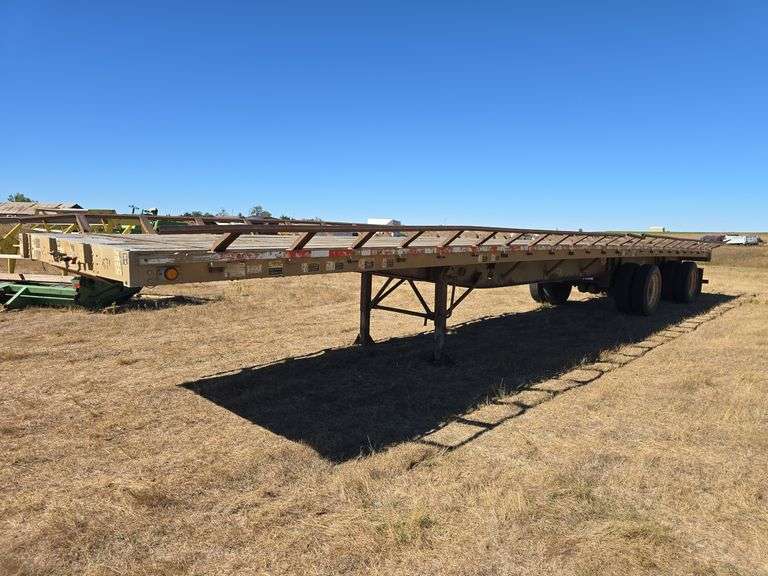 WILSON TRAILER SALES ROAD BRUTE FLATBED SEMI TRAILER. SOME RUST. HAY RACKS. 8' WIDE X 48' LONG. *** SELLS WITH TITLE***