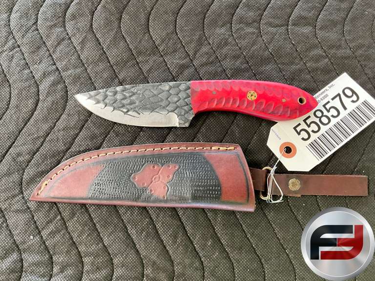 KNIFE WITH A RED CARVED HANDLE AND A TEXTURED BLADE