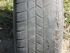Hankook P205/70R15 tire on 5-hole rim - Johnson Auction