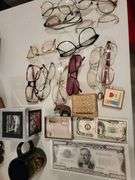 Currency notepads, vintage glasses, small photo desktop clock