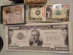 Currency notepads, vintage glasses, small photo desktop clock