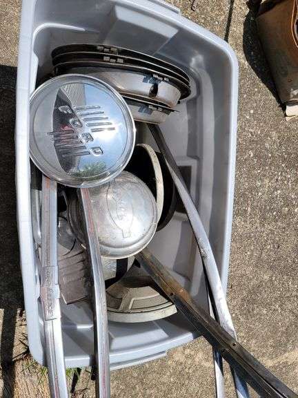 Tote containing hubcaps, hood ornaments, and chrome for Ford Super Deluxe
