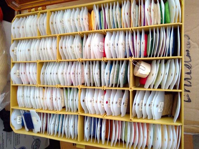 Tacklebox filled on both sides with numerous colors of thread