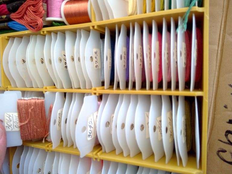 Tacklebox filled on both sides with numerous colors of thread