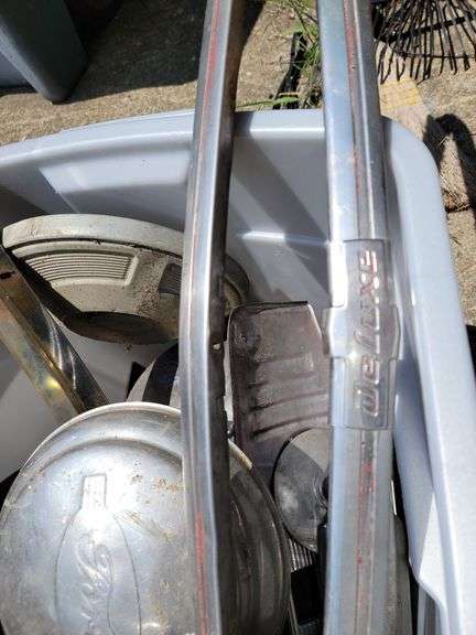 Tote containing hubcaps, hood ornaments, and chrome for Ford Super Deluxe