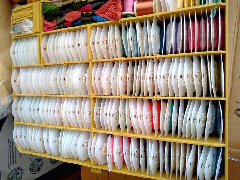 Tacklebox filled on both sides with numerous colors of thread