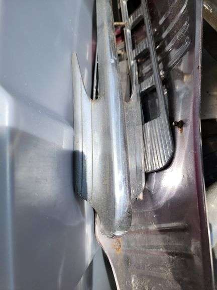 Tote containing hubcaps, hood ornaments, and chrome for Ford Super Deluxe