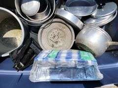 Tote full of camping items, pots, pans, etc