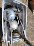 Tote containing hubcaps, hood ornaments, and chrome for Ford Super Deluxe