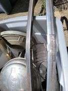 Tote containing hubcaps, hood ornaments, and chrome for Ford Super Deluxe