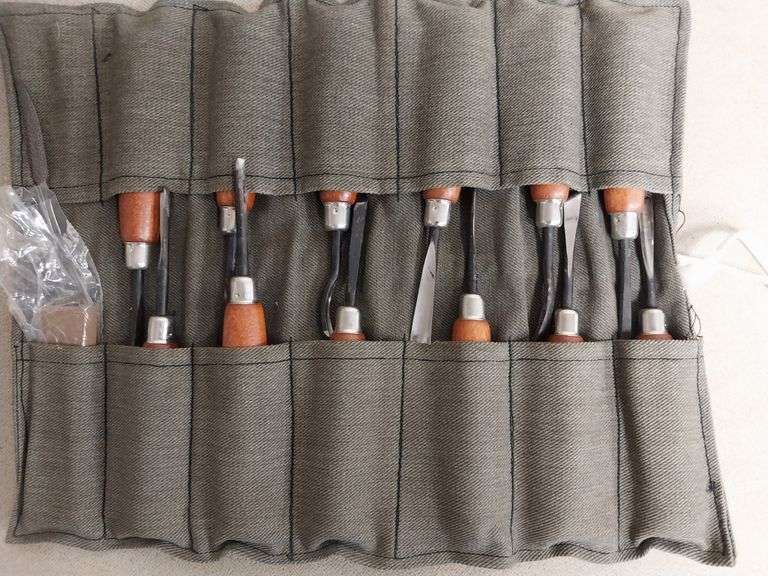 Set of wood carving chisels and hand tools plus wood carving book
