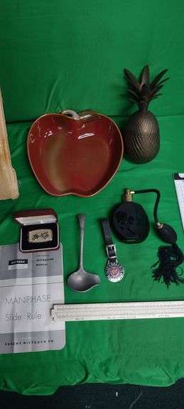 Lot containing slide rule, money clip, Seaboard Railroad Watch FOB, Brass Pineapple and more