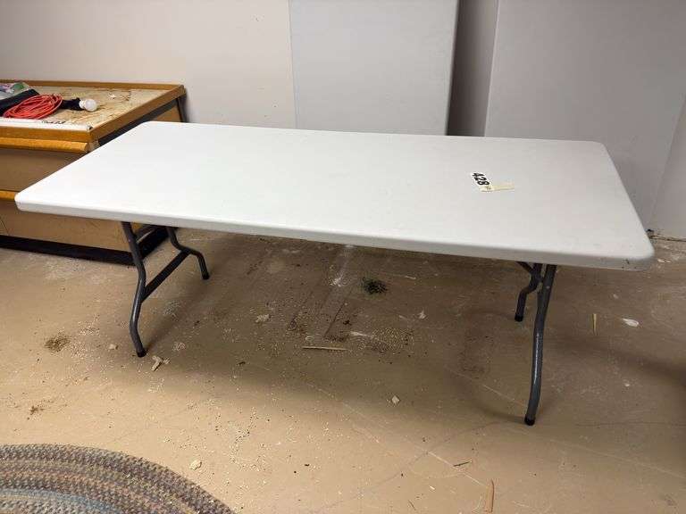 Two plastic folding tables 6 feet long