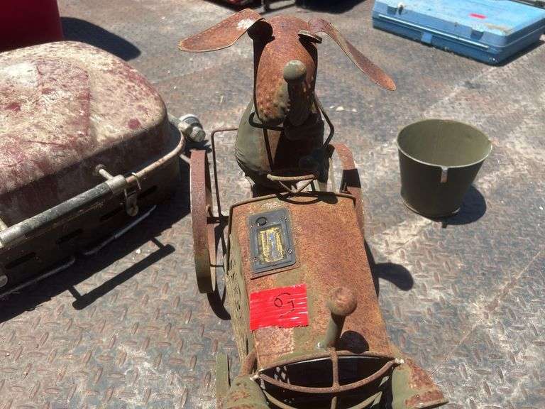 Dog on tractor lawn ornament