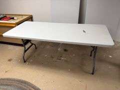 Two plastic folding tables 6 feet long