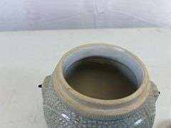 Antique stoneware jar with handle and lid
