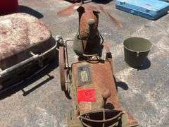 Dog on tractor lawn ornament